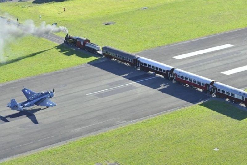 Trains cross the runway in New Zealand - one of the weirdest railway designs
